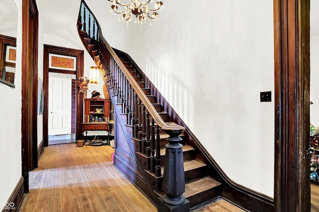 2490 S County Road 60 E, Greensburg, IN 47240 - staircase with a chandelier, hardwood / wood-style floors, and baseboards