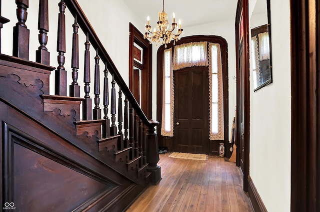 2490 S County Road 60 E, Greensburg, IN 47240 - foyer entrance featuring a chandelier, hardwood / wood-style flooring, stairs, arched walkways, and baseboards