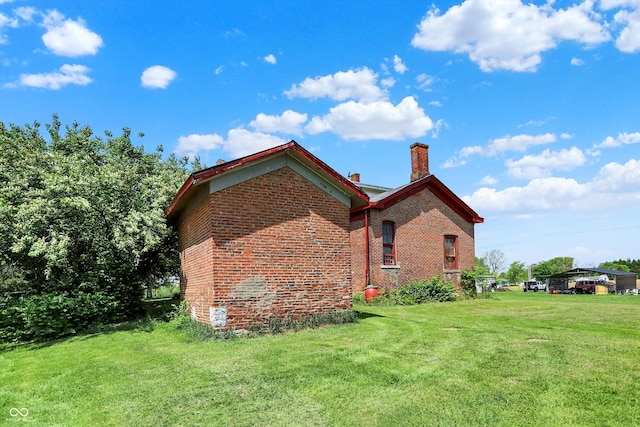 2490 S County Road 60 E, Greensburg, IN 47240 - view of side of property featuring a chimney, brick siding, and a yard