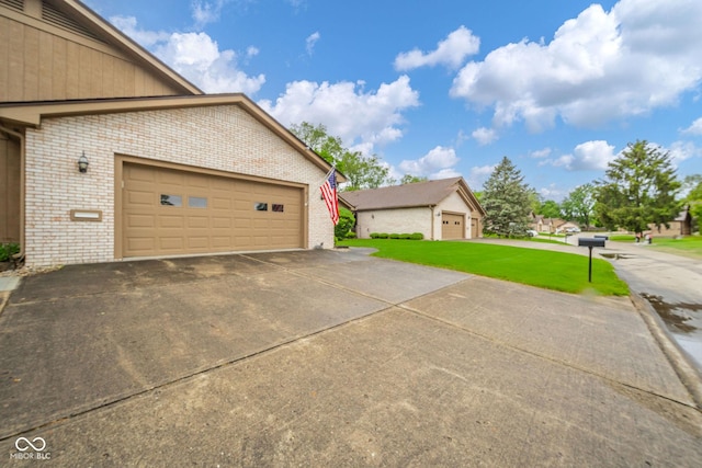 3537 Woodglen Way, Anderson, IN 46011 - view of side of property featuring brick siding, a yard, and a garage