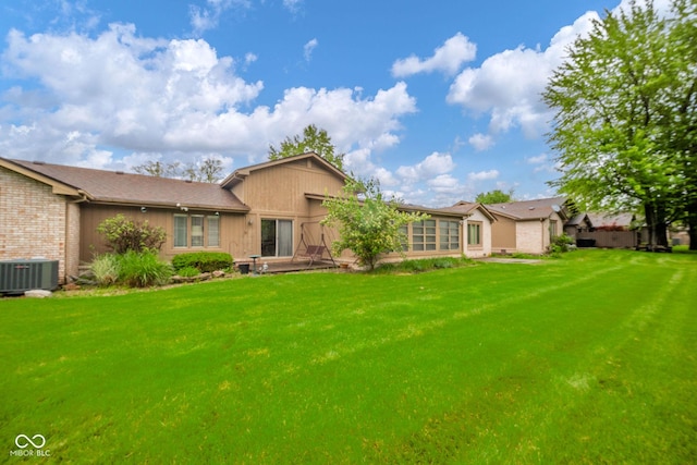 3537 Woodglen Way, Anderson, IN 46011 - back of property featuring cooling unit, a lawn, and brick siding