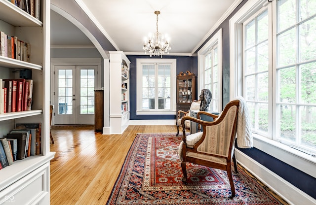 4130 N Meridian St, Indianapolis, IN 46208 - living area with ornamental molding, plenty of natural light, arched walkways, and a chandelier