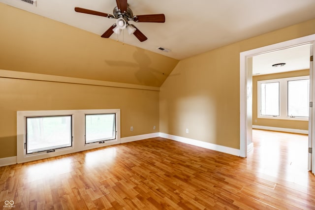 4130 N Meridian St, Indianapolis, IN 46208 - additional living space featuring a ceiling fan, plenty of natural light, light wood-style flooring, vaulted ceiling, and baseboards