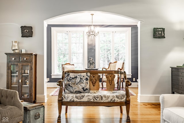 4130 N Meridian St, Indianapolis, IN 46208 - living area featuring arched walkways, a chandelier, baseboards, light wood-type flooring, and ornamental molding