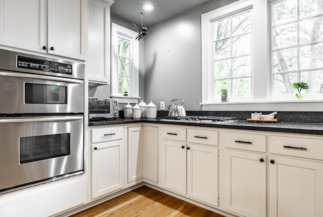4130 N Meridian St, Indianapolis, IN 46208 - kitchen with stainless steel appliances, healthy amount of natural light, light wood-type flooring, white cabinetry, and recessed lighting