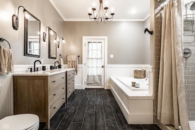 4130 N Meridian St, Indianapolis, IN 46208 - bathroom featuring wainscoting, wood finished floors, crown molding, a chandelier, and a bath