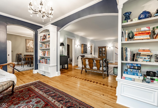 4130 N Meridian St, Indianapolis, IN 46208 - living area with arched walkways, light wood-style flooring, crown molding, a chandelier, and baseboards