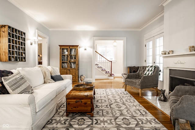 4130 N Meridian St, Indianapolis, IN 46208 - living area featuring crown molding, stairs, wood finished floors, baseboards, and a fireplace with flush hearth