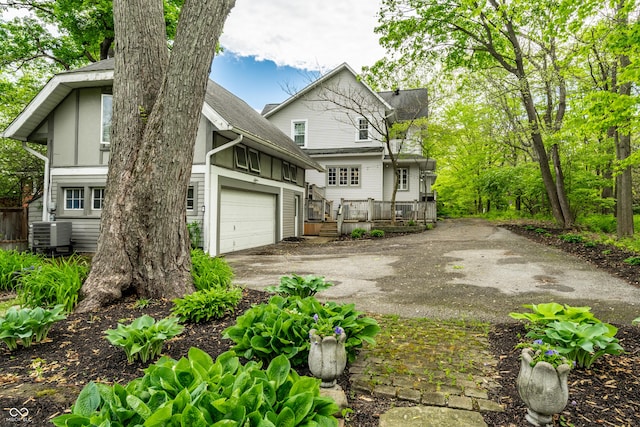 4130 N Meridian St, Indianapolis, IN 46208 - view of property exterior featuring asphalt driveway, a garage, a deck, and cooling unit