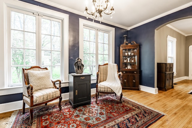 4130 N Meridian St, Indianapolis, IN 46208 - sitting room featuring arched walkways, plenty of natural light, hardwood / wood-style floors, a chandelier, and ornamental molding