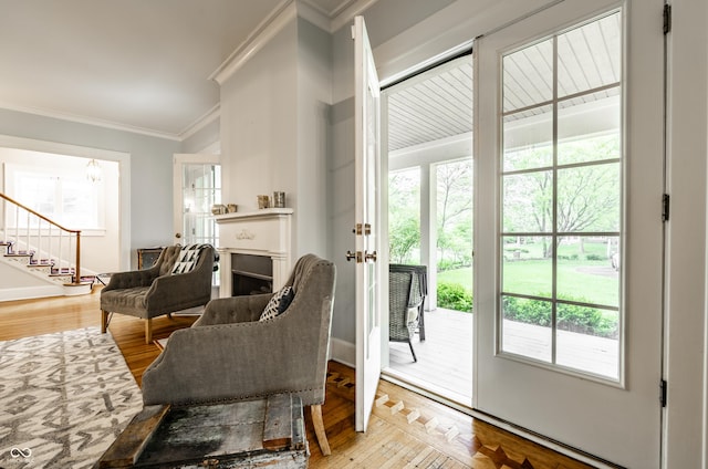 4130 N Meridian St, Indianapolis, IN 46208 - entryway with ornamental molding, light wood-style floors, baseboards, stairway, and a fireplace