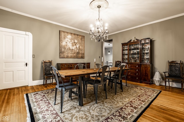 4130 N Meridian St, Indianapolis, IN 46208 - dining room with a chandelier, hardwood / wood-style flooring, ornamental molding, and baseboards