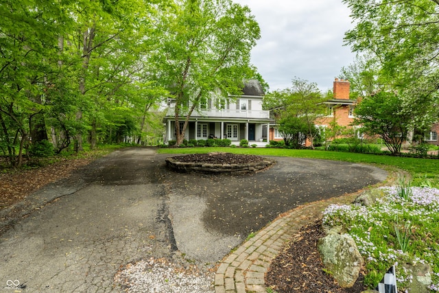 4130 N Meridian St, Indianapolis, IN 46208 - view of front facade featuring driveway, a chimney, and covered porch