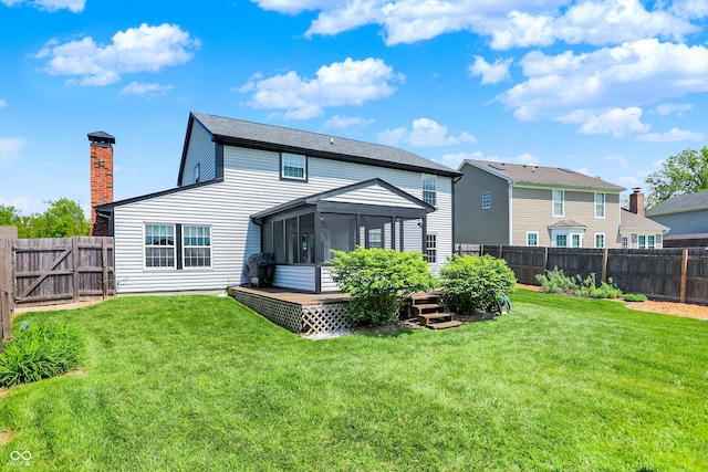 rear view of property with a sunroom, a deck, and a chimney