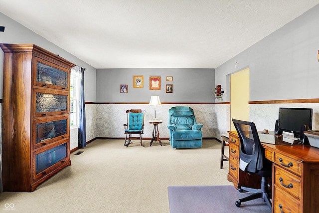 carpeted office space with baseboards and wainscoting