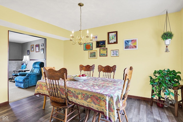 dining area featuring hardwood / wood-style floors, a chandelier, and baseboards