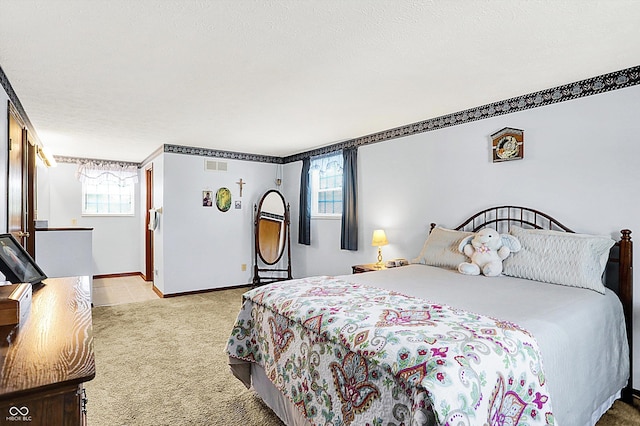bedroom with light colored carpet and baseboards
