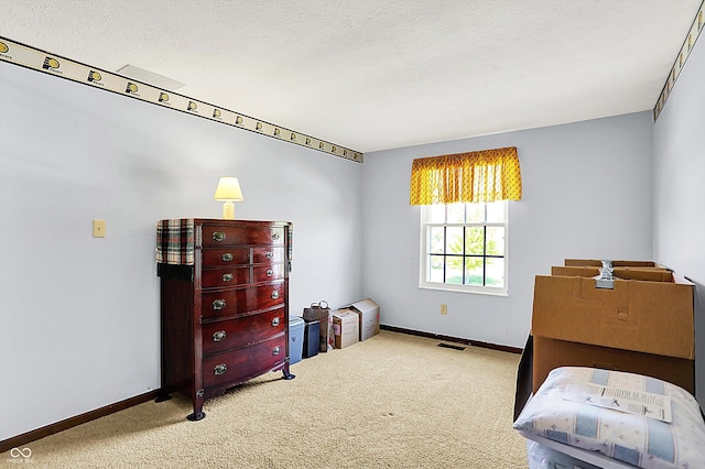 bedroom featuring baseboards, carpet floors, and a textured ceiling