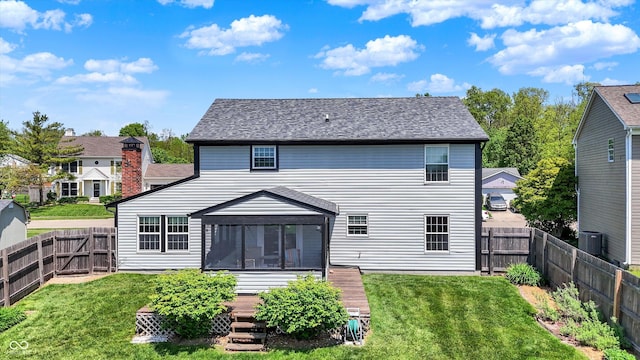 rear view of house with a sunroom, cooling unit, and a deck