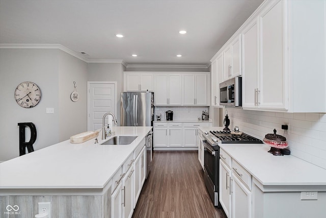5020 Eldon Dr, Noblesville, IN 46062 - kitchen featuring appliances with stainless steel finishes, a sink, ornamental molding, dark wood-style floors, and recessed lighting