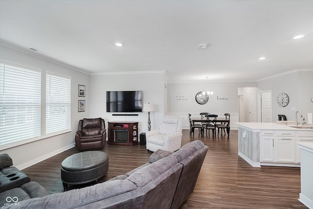 5020 Eldon Dr, Noblesville, IN 46062 - living area with crown molding, dark wood-type flooring, recessed lighting, baseboards, and a chandelier