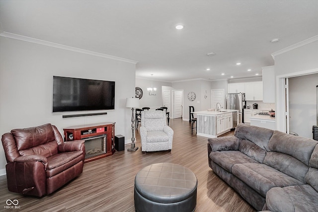 5020 Eldon Dr, Noblesville, IN 46062 - living area featuring wood finished floors, crown molding, recessed lighting, and baseboards