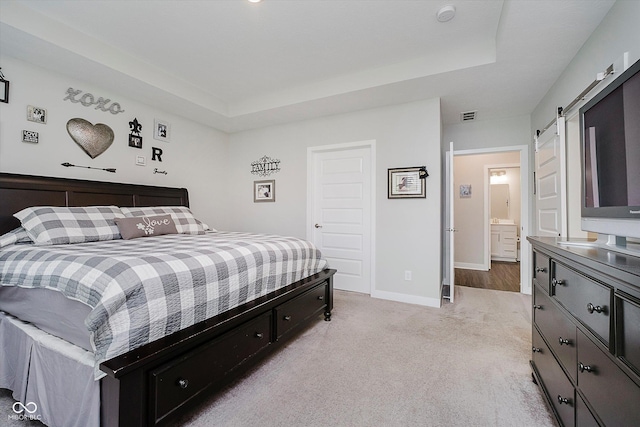 5020 Eldon Dr, Noblesville, IN 46062 - bedroom featuring light colored carpet, a tray ceiling, baseboards, and a barn door