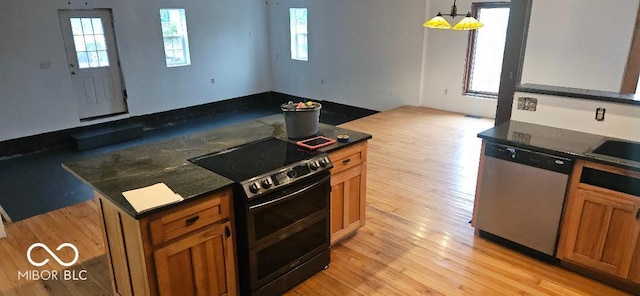 3854 Three Mile Rd, Centerville, IN 47330 - kitchen with stainless steel dishwasher, black range with electric stovetop, light wood-style flooring, and brown cabinetry