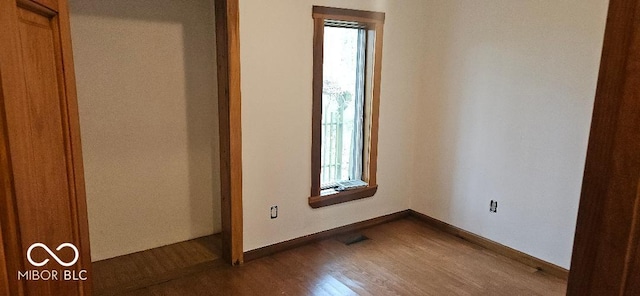 3854 Three Mile Rd, Centerville, IN 47330 - unfurnished bedroom with multiple windows, dark wood-type flooring, and baseboards