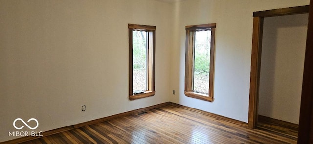 3854 Three Mile Rd, Centerville, IN 47330 - empty room with dark wood finished floors and baseboards