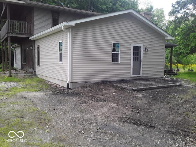 3854 Three Mile Rd, Centerville, IN 47330 - back of house with a chimney and a balcony