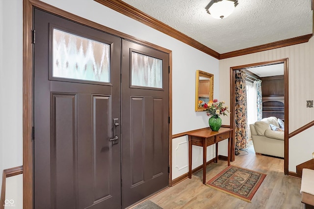 781 Dayton Dr, Carmel, IN 46033 - entryway featuring light wood-type flooring, ornamental molding, a textured ceiling, and baseboards