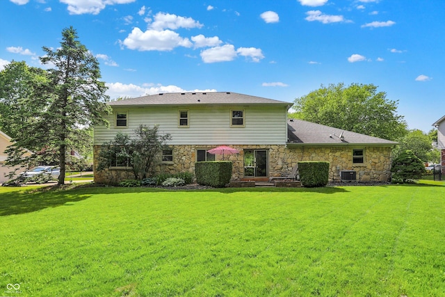 781 Dayton Dr, Carmel, IN 46033 - back of house featuring stone siding, a lawn, and central air condition unit