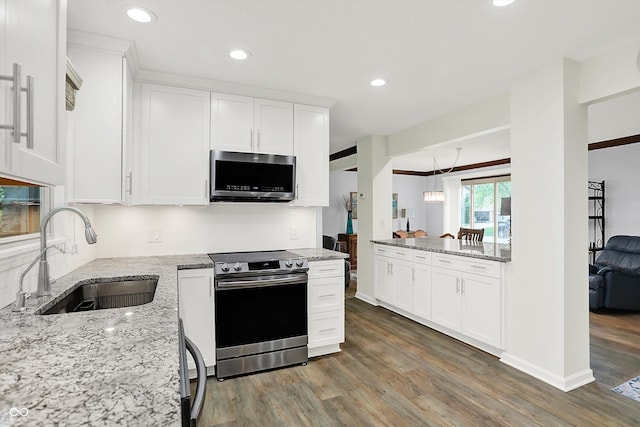 781 Dayton Dr, Carmel, IN 46033 - kitchen featuring stainless steel appliances, a sink, dark wood-style flooring, backsplash, and white cabinetry