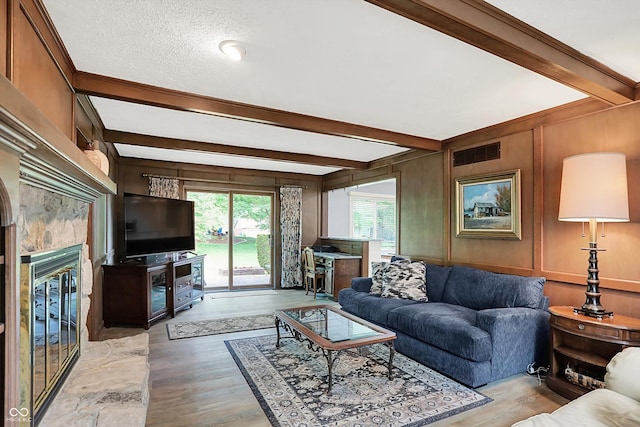 781 Dayton Dr, Carmel, IN 46033 - living room featuring beam ceiling, light wood-style floors, and a glass covered fireplace