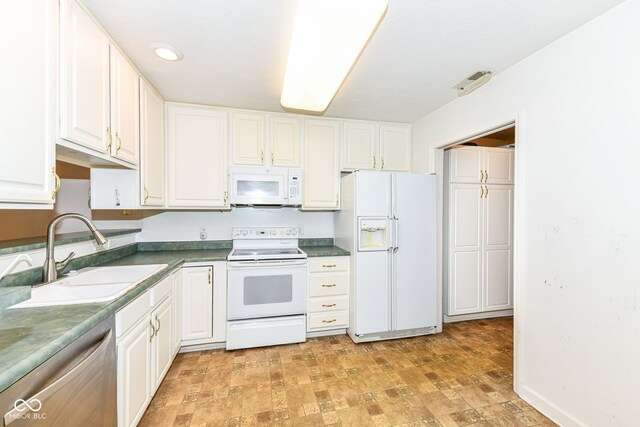7645 Briarstone Ln, Indianapolis, IN 46227 - kitchen featuring white appliances, white cabinets, and dark countertops