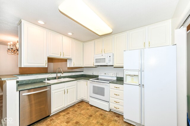 7645 Briarstone Ln, Indianapolis, IN 46227 - kitchen with white appliances, dark countertops, recessed lighting, a chandelier, and white cabinetry