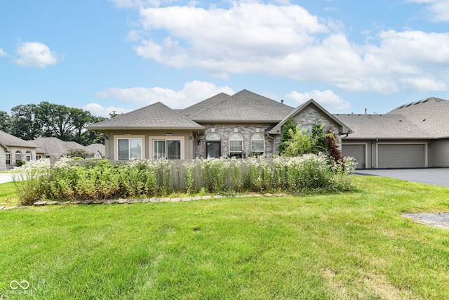 7645 Briarstone Ln, Indianapolis, IN 46227 - french provincial home featuring an attached garage, asphalt driveway, a front lawn, stone siding, and a shingled roof