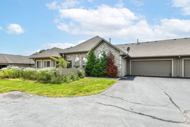 7645 Briarstone Ln, Indianapolis, IN 46227 - view of front facade with asphalt driveway, an attached garage, a shingled roof, and brick siding