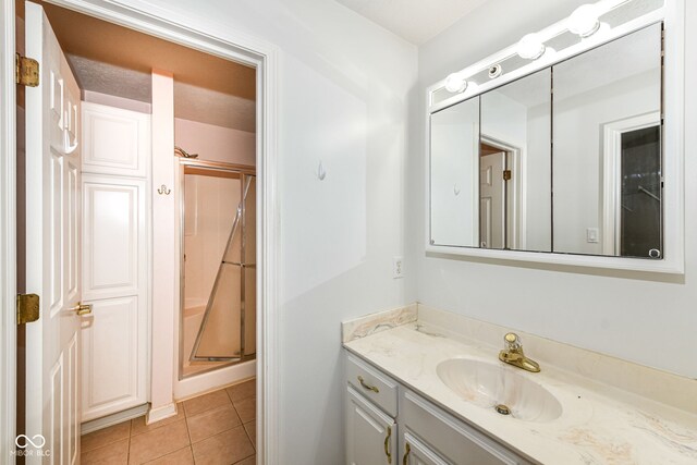 7645 Briarstone Ln, Indianapolis, IN 46227 - bathroom with vanity, a shower stall, and tile patterned floors
