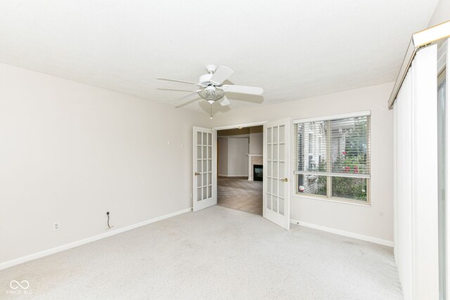 7645 Briarstone Ln, Indianapolis, IN 46227 - spare room with french doors, light colored carpet, and a ceiling fan