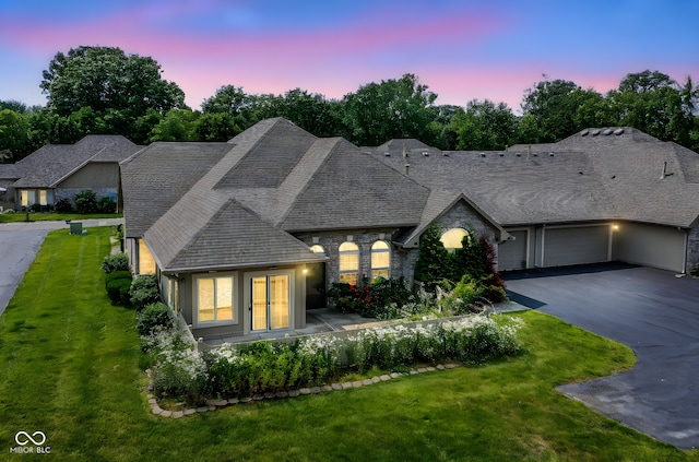 7645 Briarstone Ln, Indianapolis, IN 46227 - view of front of home featuring a yard, stone siding, driveway, a garage, and french doors