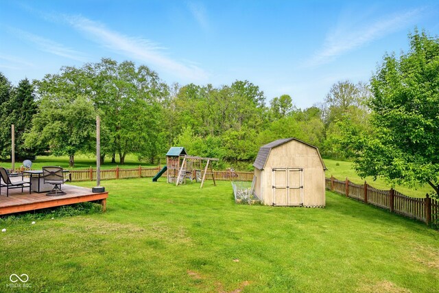 6462 Wings Ct, Brownsburg, IN 46112 - view of yard featuring a storage unit, a playground, a wooden deck, and an outbuilding
