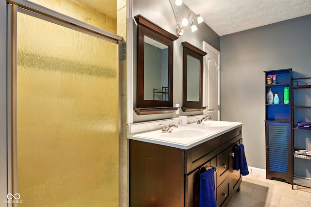 6462 Wings Ct, Brownsburg, IN 46112 - bathroom with a shower stall, double vanity, a textured ceiling, and tile patterned flooring