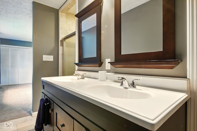 6462 Wings Ct, Brownsburg, IN 46112 - bathroom with a textured ceiling, a shower with door, and double vanity