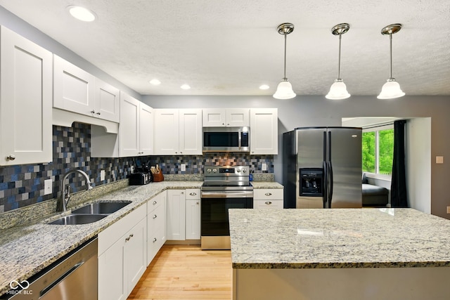 6462 Wings Ct, Brownsburg, IN 46112 - kitchen with stainless steel appliances, a sink, white cabinetry, recessed lighting, and a textured ceiling