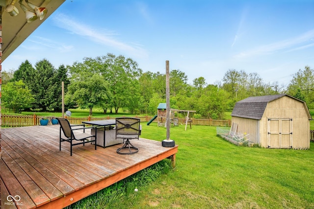 6462 Wings Ct, Brownsburg, IN 46112 - deck featuring a shed, an outdoor structure, view of wooded area, and a playground