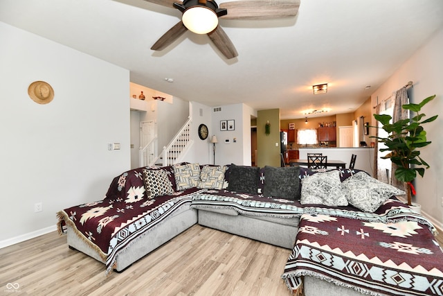 7604 Cloudy Ct, Camby, IN 46113 - living room with light wood finished floors, a ceiling fan, stairway, and baseboards