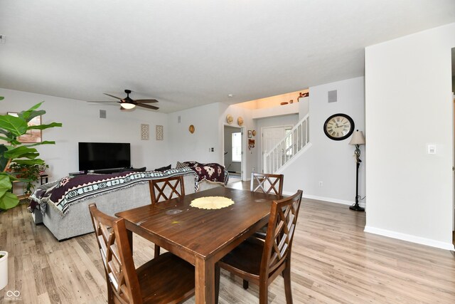 7604 Cloudy Ct, Camby, IN 46113 - dining space featuring light wood-style floors, ceiling fan, stairway, and baseboards