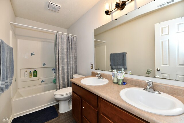 7604 Cloudy Ct, Camby, IN 46113 - full bath featuring double vanity, shower / tub combo with curtain, toilet, and wood finished floors